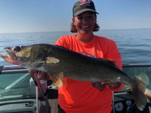 Pro angler Nancy Koep holding fish on boat