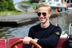 Man smiling on a boat. Let's get your boat ready for spring!