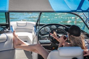 Woman driving a boat with her feet up!
